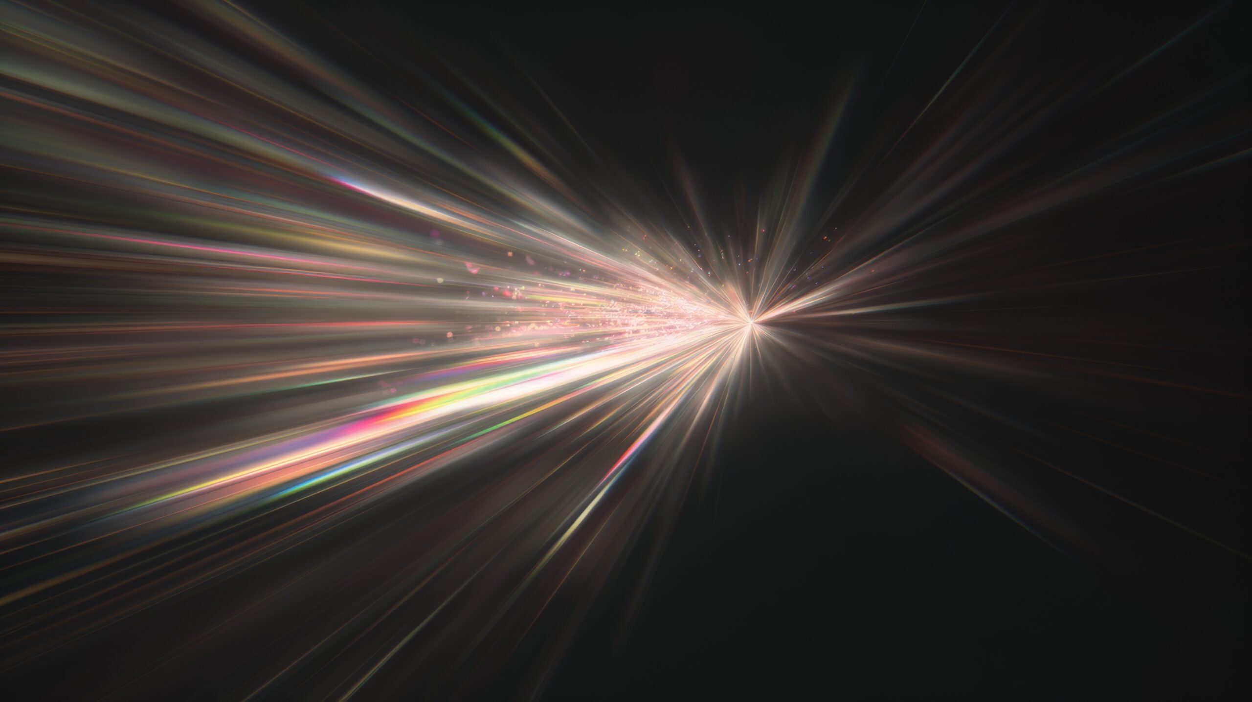 Abstract light beams or lens flare coming out of a black background